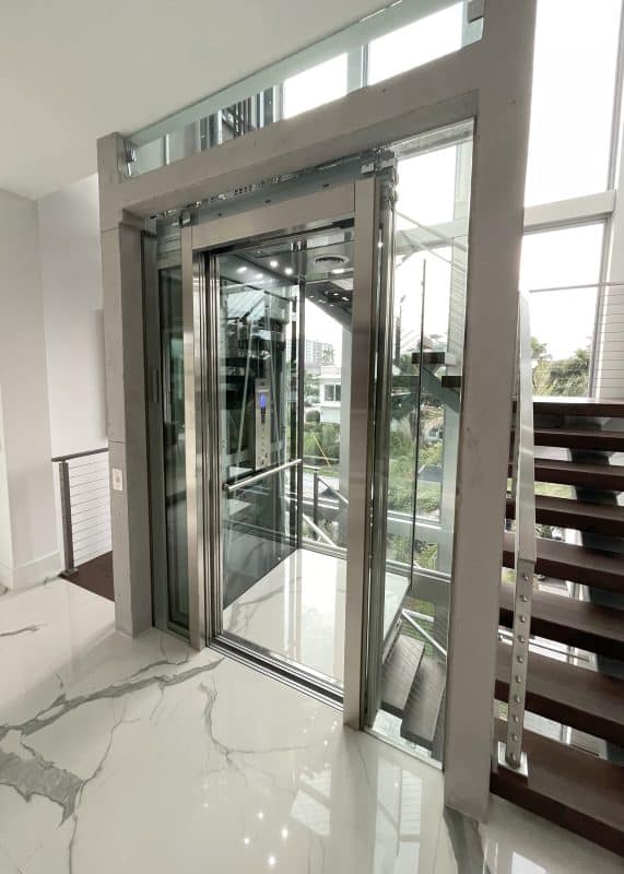 https://elevatorworld.com/wp-content/uploads/2023/05/Savaria-Eclipse-glass-home-elevator-in-Delray-Beach-571x800.jpg