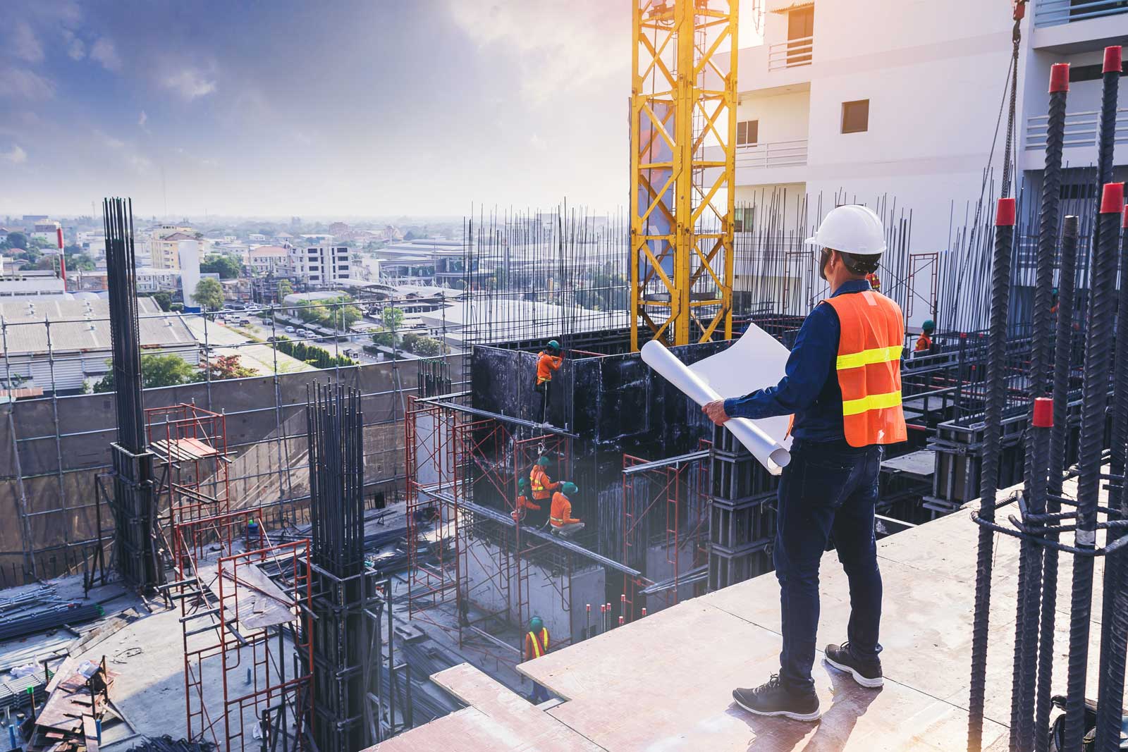 Smart civil architect engineer inspecting and working outdoors building side with blueprints. engineering and architecture concept. VT Trends