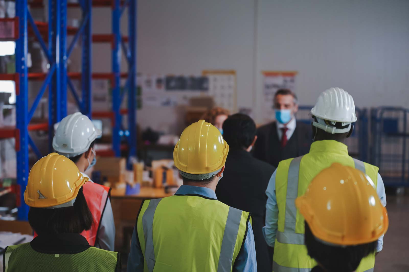 Manager and warehouse work team discuss preventive measures, spa