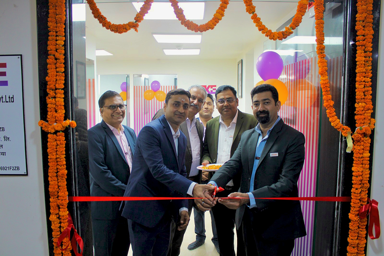 TKE India CEO and MD Manish Mehan, right, cuts the ribbon on the new office with local leaders; image courtesy of TKE India.