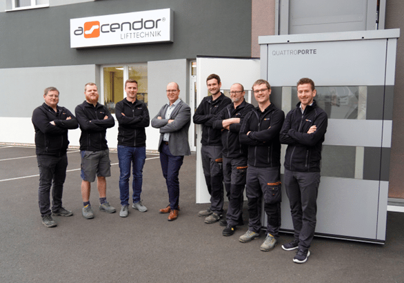 Managing Director Erwin Roither (fourth from left), Head of Sales Julian Grad (right) and the Ascendor team leaders from production; photo courtesy of Ascendor Lifttechnik