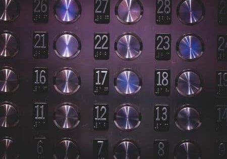 Raised elevator floor numbers with corresponding braille below; image by StockSnap from Pixabay  