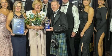 The Renwick family accepts the award; image via The Courier. 