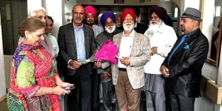 Harry Bains (holding the bouquet) with members of Surrey-Delta Indo Canadian Seniors Society; image via Indo-Canadian Voice