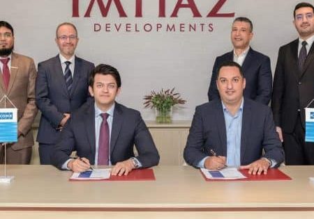 The Imtiaz Developments and KONE teams celebrate signing the deal; image via Construction Week. 