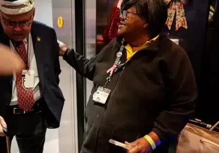 Martha Booker welcomes radio broadcaster Peter Weber onto her elevator; image courtesy of Andrew Nelles for The Tennessean. 