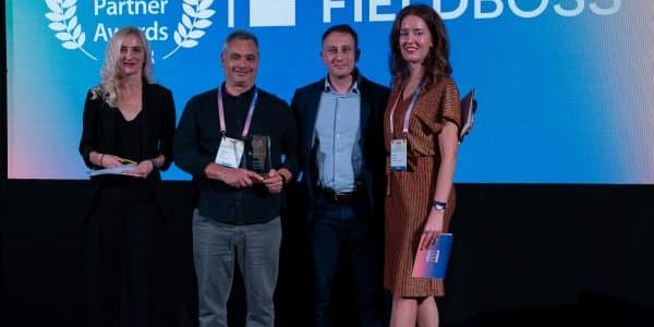 FIELDBOSS CEO Jonathan Taub, second from left, accepts the award; photo courtesy of FIELDBOSS.  