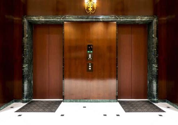 Front of Two close elevators in old retro style Hotel