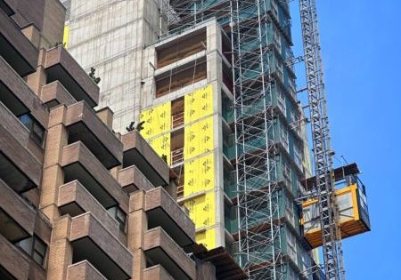 Construction hoists traverse the exterior of the structure; photo by Michael Young for New York YIMBY.
