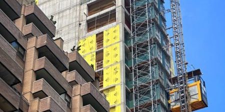 Construction hoists traverse the exterior of the structure; photo by Michael Young for New York YIMBY.