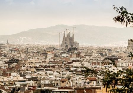 Barcelona skyline, including the famous Sagrada Família basilica designed by Antoni Gaudí; photo by jarmoluk for Pixabay