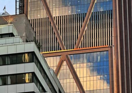 The reflective glass and bronze-hued cladding covers more of the skyscraper; photo by Michael Young for New York YIMBY. 