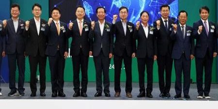 Hyundai Elevator CEO Cho Jae-cheon, eighth from left, poses with participants at the launching ceremony for K-Escalator in Geochang County, South Gyeongsang Province; image courtesy of Hyundai Elevator. 