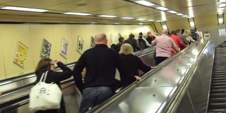 Escalators at the entrance to the busy Moorfields station; photo by ReptOn1x for Wikipedia