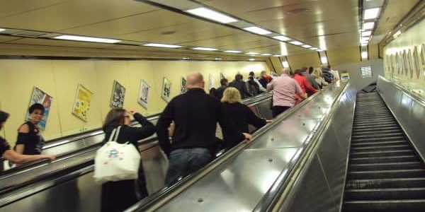 Escalators at the entrance to the busy Moorfields station; photo by ReptOn1x for Wikipedia