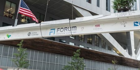 Representatives from Lendlease, Ivanhoé Cambridge and Consigli Construction Co. celebrate the topping-out of Forum, a $545 life sciences project in Boston on Sept. 14; photo courtesy of Lendlease via Construction Dive. 