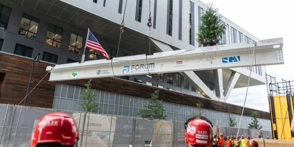 Representatives from Lendlease, Ivanhoé Cambridge and Consigli Construction Co. celebrate the topping-out of Forum, a $545 life sciences project in Boston on Sept. 14; photo courtesy of Lendlease via Construction Dive. 