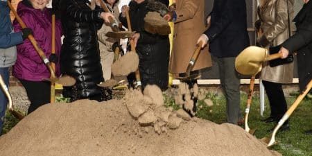 A groundbreaking ceremony took place on April 3 to kick off installation of the new elevator at the DeSales Center. (l-r) are DeSales Center board members Mary Ellen Luker and Matt Grove, Board President Ellen Luley, Empire State Development Mohawk Valley Regional Director Allison Madmoune, Adirondack Bank Vice President of Commercial Lending Ann Gaworecki, Thea Bowman House Executive Director Jane Domingue, Thea Bowman House alumni/board member Julius Blackshear, Jr., Oneida County Executive Anthony J. Picente Jr., Rosemary Bonacci, Roann Destito and Thea Bowman House board member/treasurer William Taft; image courtesy of Thea Bowman House via The Central New York Business Journal. 