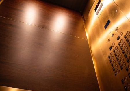The modernized cabs feature African mahogany wood panels; image courtesy of Troutman Elevator Interiors.