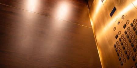 The modernized cabs feature African mahogany wood panels; image courtesy of Troutman Elevator Interiors.