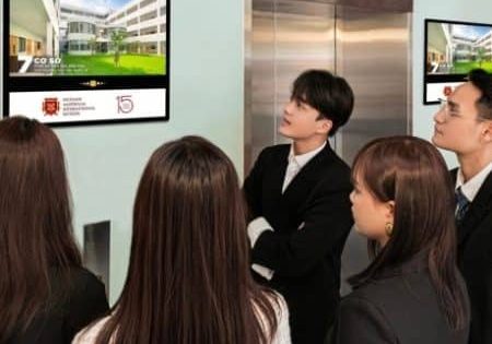 Elevator passengers check out the ad screens; image courtesy of Chicilon Media. 