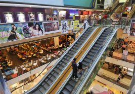 Shoppers ride escalators at a mall in Mumbai; image from The Hindu.